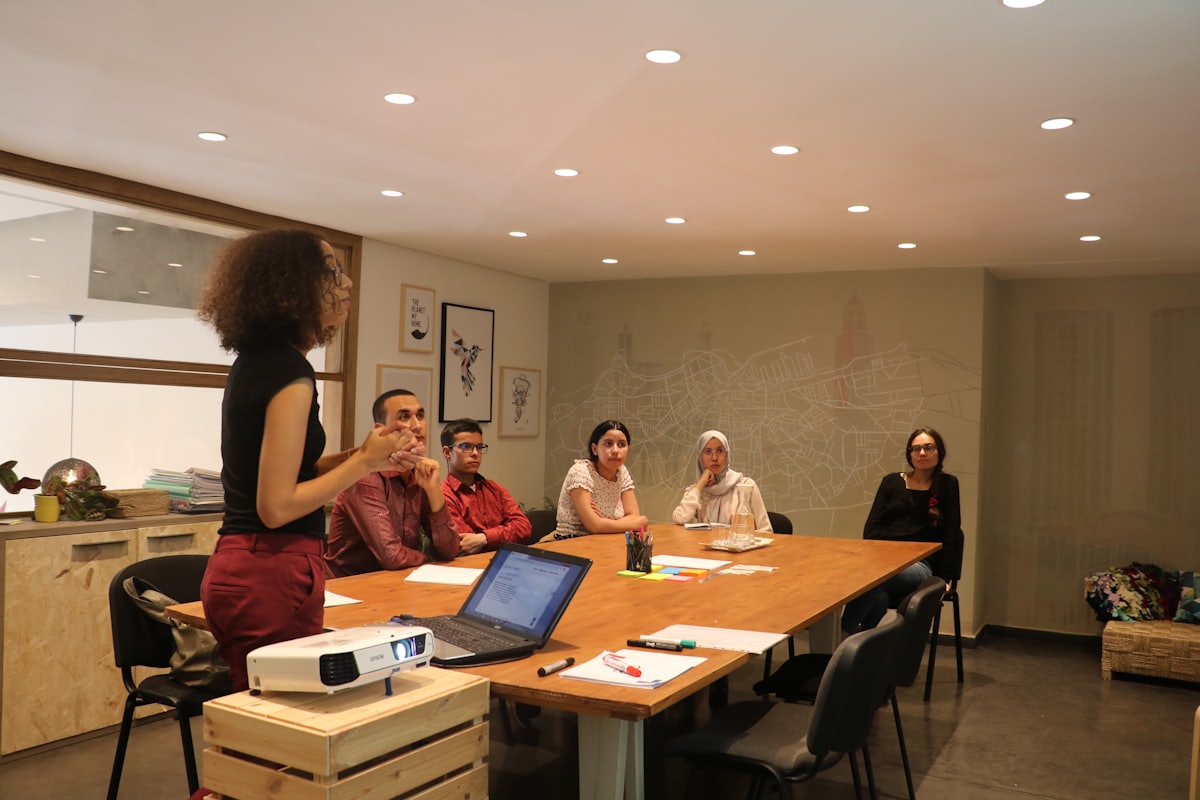 A facilitator teaching a small, diverse group of women