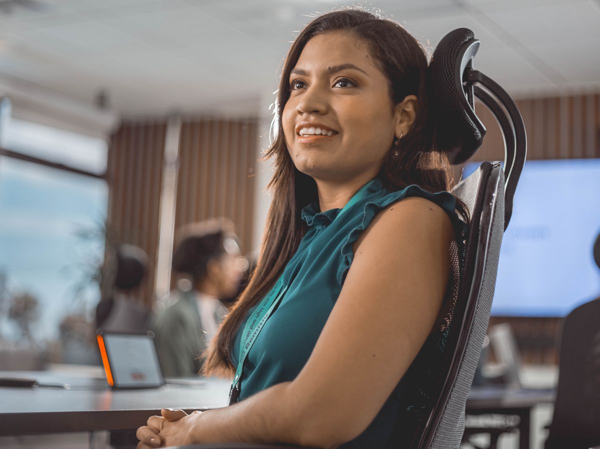 A professional woman at her desk in a modern office