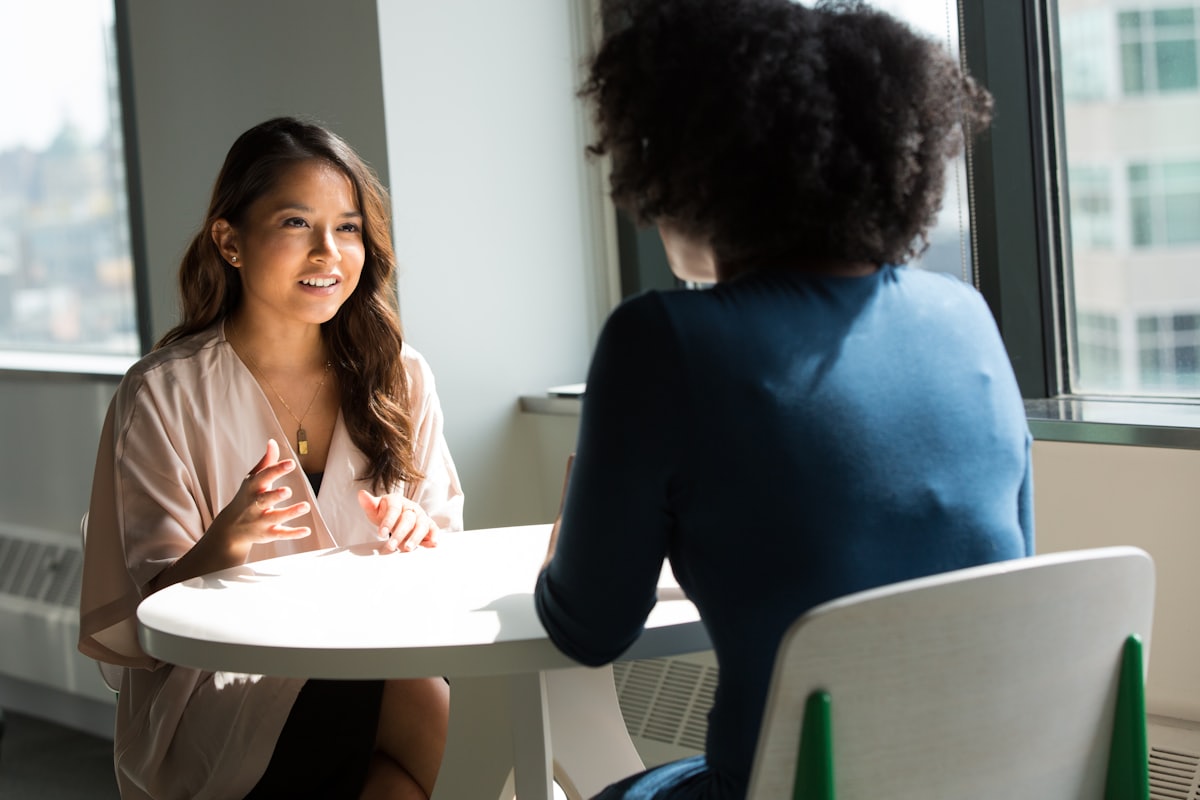 Two women in a supportive one-on-one conversation
